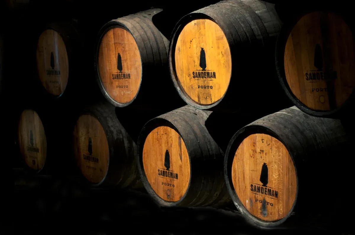 Stacked port wine barrels in Vila Nova de Gaia on a sommelier Douro Valley wine tour from Porto