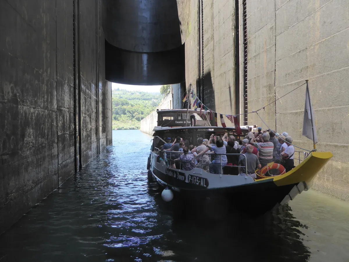 Cruise boat inside the Carrapatelo dam lock on a Douro river cruise, part of a Douro Valley wine tour from Porto