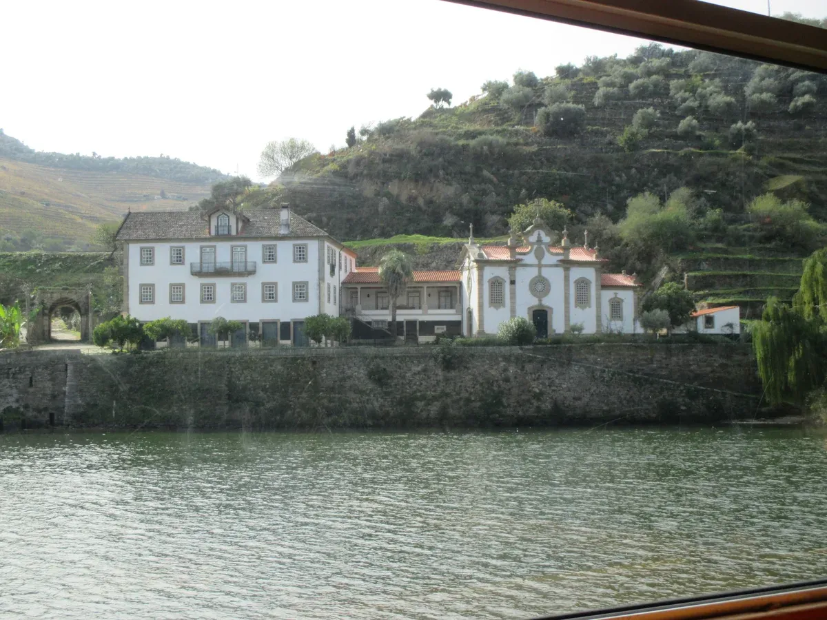 Quinta on the Douro riverbank seen from the water on a private boat Douro Valley wine tour from Porto
